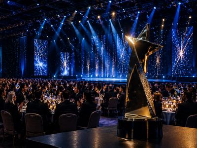 A trophy on stage at a formal corporate awards gala